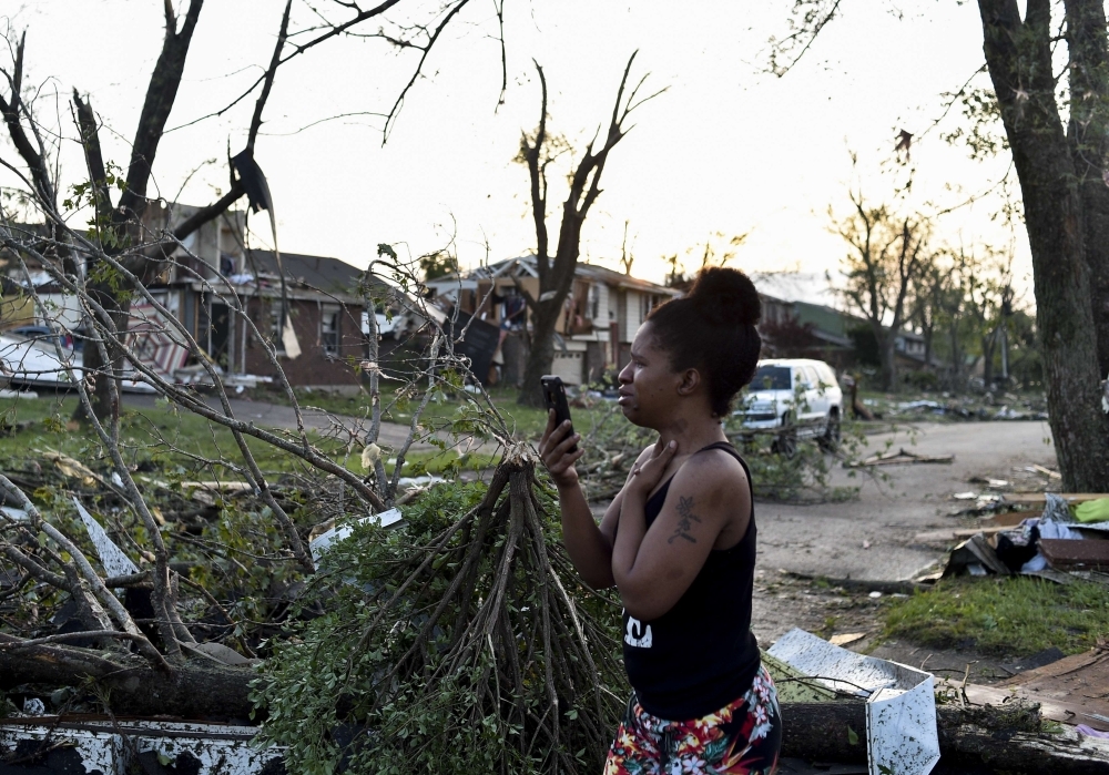 A car and truck sit under a fallen tree the morning after a tornado touched down overnight in Trotwood near Dayton, Ohio, US, on Tuesday. — Reuters