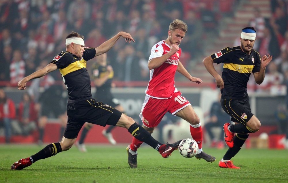 Union Berlin's Swedish forward Sebastian Andersson (C) vies for the ball with Stuttgart's German defender Holger Badstuber (L) and Stuttgart's Turkish defender Ozan Kabak during the German Bundesliga Relegation second-leg football match in Berlin, on Monday. — AFP