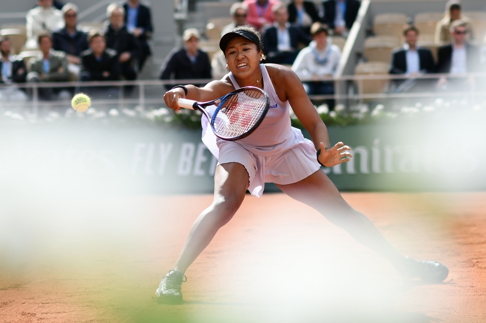 Japan's Naomi Osaka returns the ball to Slovakia's Anna Karolina Schmiedlova during their women's singles first round match on day three of The Roland Garros 2019 French Open tennis tournament in Paris on Tuesday. — AFP