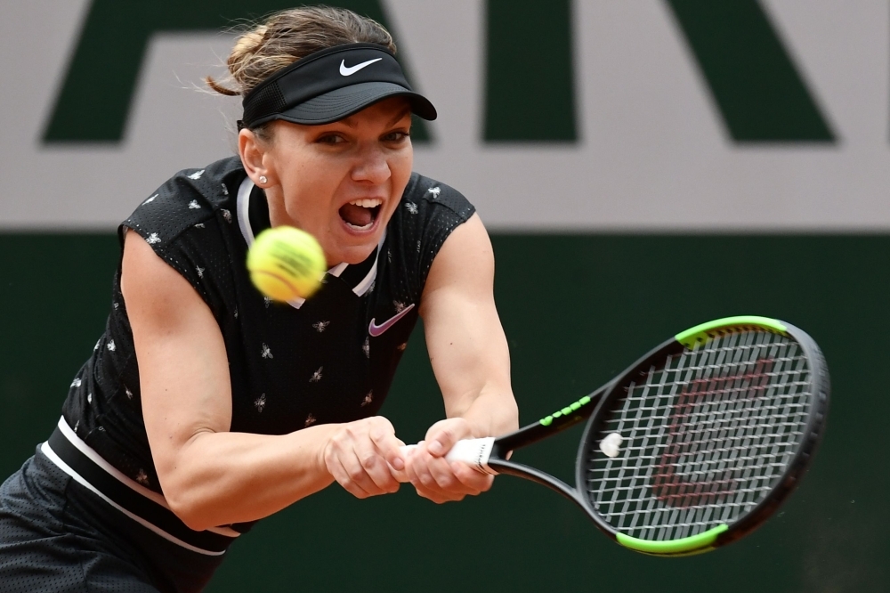 Japan's Naomi Osaka returns the ball to Slovakia's Anna Karolina Schmiedlova during their women's singles first round match on day three of The Roland Garros 2019 French Open tennis tournament in Paris on Tuesday. — AFP