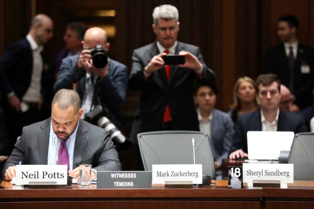 People photograph nameplates after Facebook CEO Mark Zuckerberg and COO Sheryl Sandberg failed to appear at the International Grand Committee on Big Data, Privacy and Democracy meeting on Parliament Hill in Ottawa, Ontario, Canada, Tuesday. — Reuters