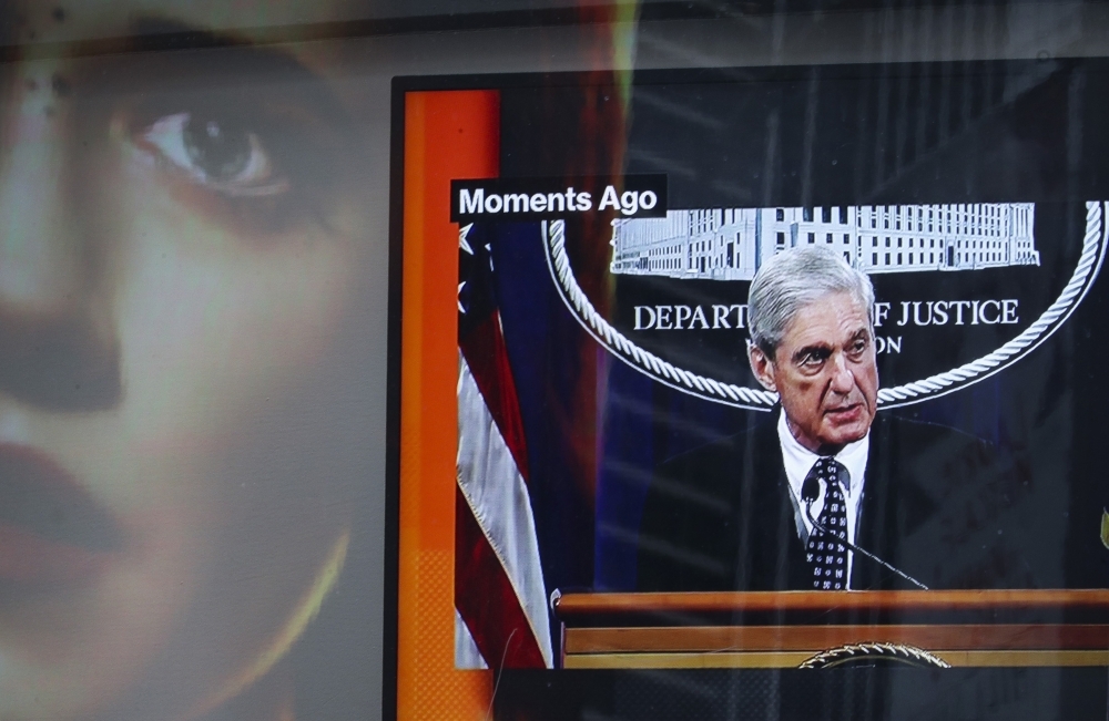 Displayed on a television screen in Times Square, Special Counsel Robert Mueller makes a statement about the Russia investigation, Wednesday in New York City. Mueller said that he is stepping down as special counsel and that the report he gave to the attorney general would be his last words on the subject. — AFP