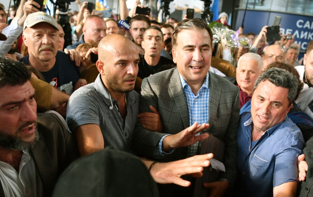 Former Georgian leader Mikheil Saakashvili (C-R) is greeted by his supporters after his arriving in Kiev's Boryspil airport on Wednesday. Ukraine's new President Volodymyr Zelensky restored the Ukrainian citizenship of Saakashvili, less than two years after he was stripped of it and expelled. — AFP