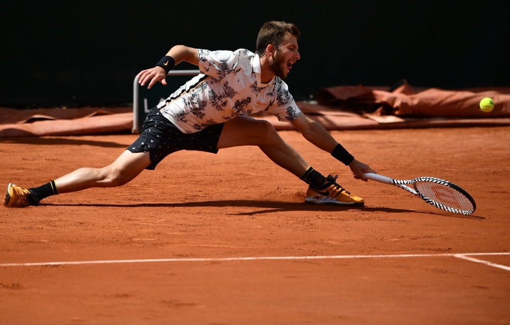 France's Corentin Moutet returns the ball to Argentina's Guido Pella during their men's singles second round match on day four of The Roland Garros 2019 French Open tennis tournament in Paris on Wednesday. — AFP