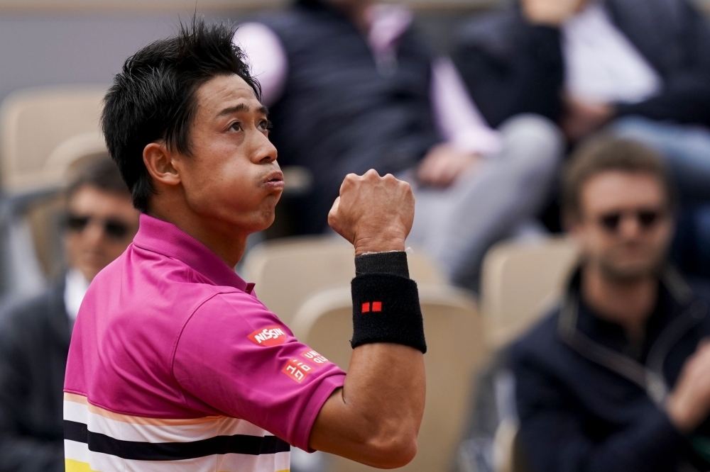 Japan's Kei Nishikori celebrates after winning against France's Jo-Wilfried Tsonga during their men's singles second round match on day four of The Roland Garros 2019 French Open tennis tournament in Paris on Wednesday. — AFP