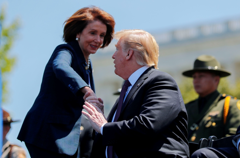 File photo shows President Donald Trump shaking hands with Speaker of the House Nancy Pelosi as they both attend the 38th Annual National Peace Officers Memorial Service on Capitol Hill in Washington, US, on May 15, 2019. — Reuters