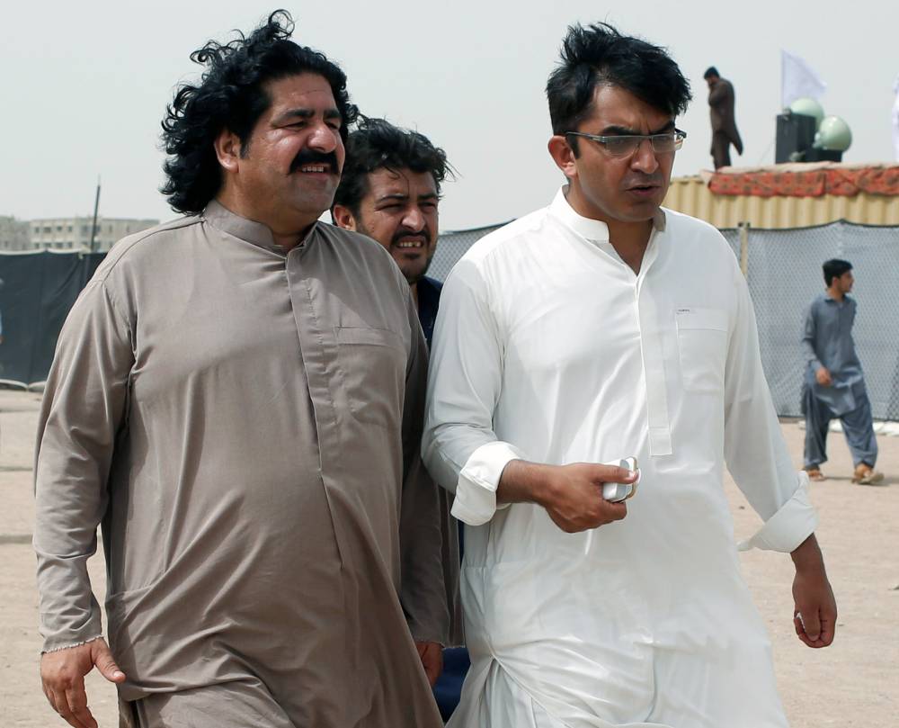 File photo shows Ali Wazir (L) and Mohsin Dawar, leaders of the Pashtun Tahaffuz Movement (PTM), walking at the venue of a rally against, what they say, are human rights violations by security forces, in Karachi, Pakistan, on May 13, 2018. — Reuters