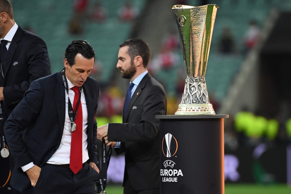 Arsenal's Spanish head coach Unai Emery walks past the trophy after losing the UEFA Europa League final football match to Chelsea FC at the Baku Olympic Stadium in Baku, Azerbaijian, on Wednesday. — AFP