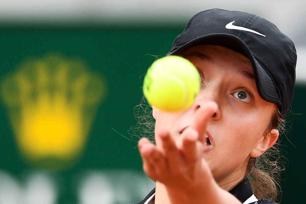Poland's Iga Swiatek serves the ball to China's Qiang Wang during their women's singles second round match on day five of The Roland Garros 2019 French Open tennis tournament in Paris on Thursday. — AFP