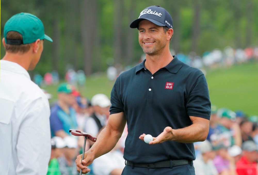 Adam Scott of Australia chats with his caddie Joh Limanti on the 2nd hole during final round play in the Masters event at the Augusta National Golf Club in Augusta, Georgia, US, in this file photo. — Reuters
