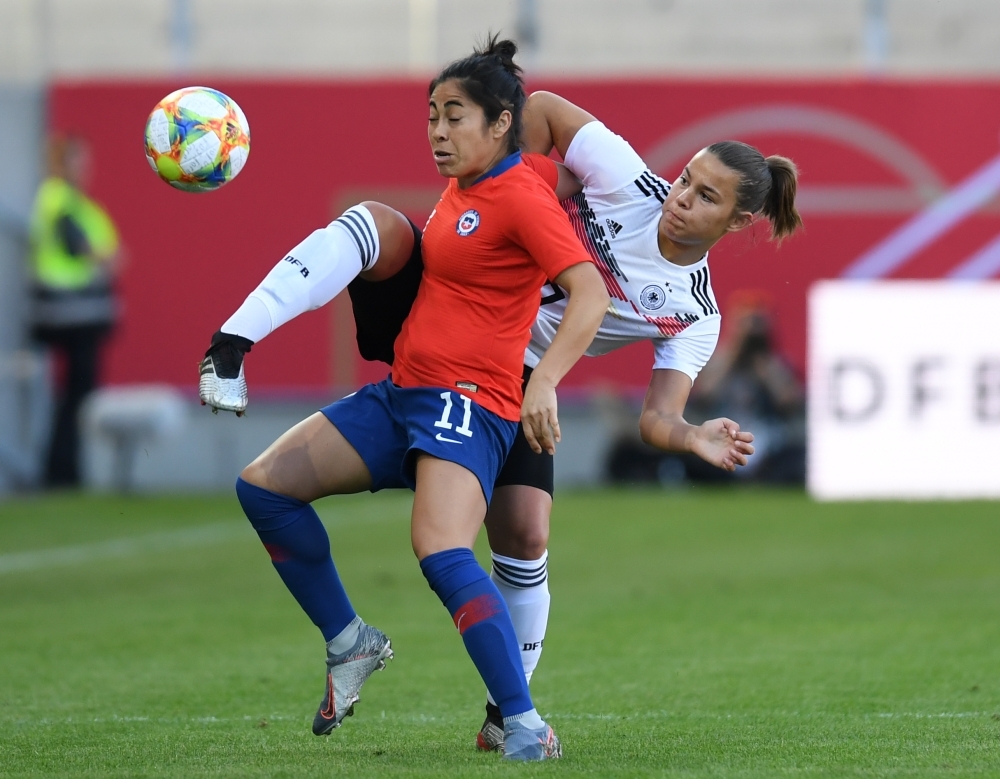 Germany's Linda Dallmann (L) and Chile's goalkeeper Christiane Endler (R) vie for the ball during a friendly women's football match between Germany and Chile in the stadium in Regensburg, southern Germany, on Thursday. — AFP