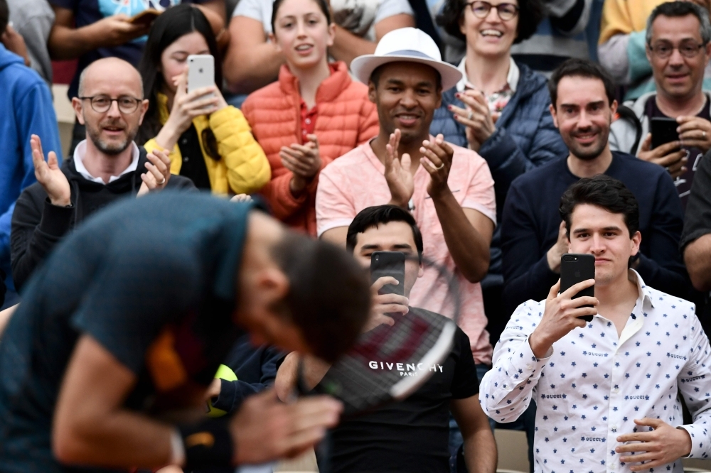 Romania's Simona Halep eyes the ball as she plays against Poland's Magda Linette during their men's singles second round match on day five of The Roland Garros 2019 French Open tennis tournament in Paris on Thursday. — AFP 