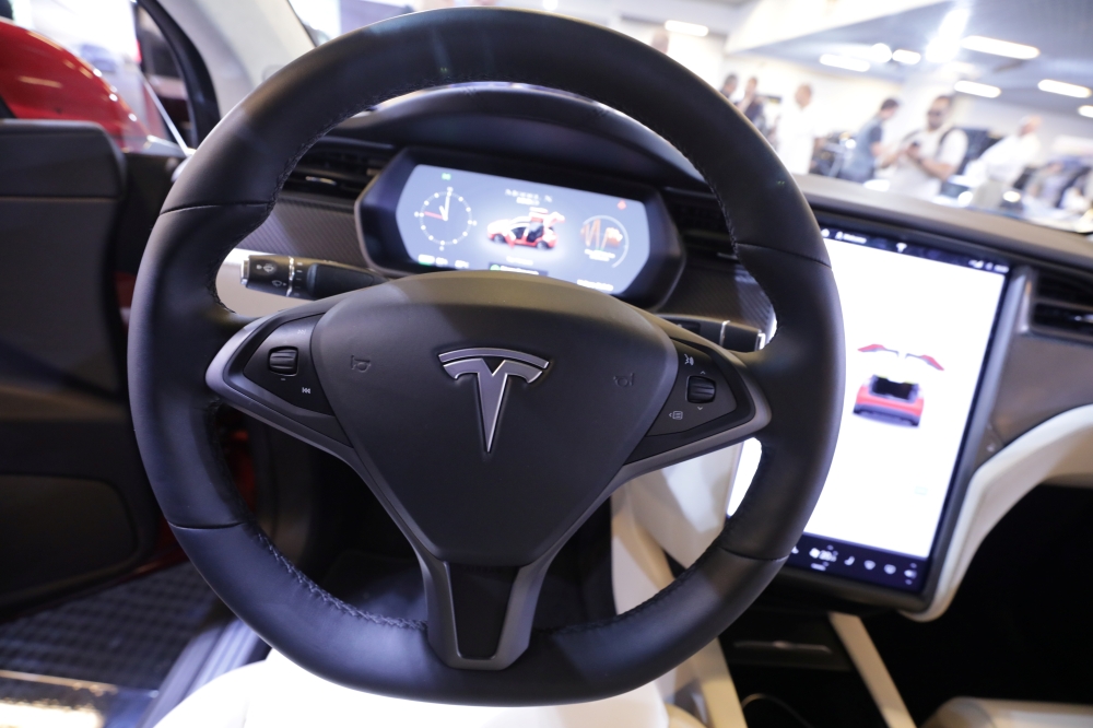 The logo of Tesla carmaker is seen inside a car at the Top Marques fair in Monaco May 30, 2019. — Reuters