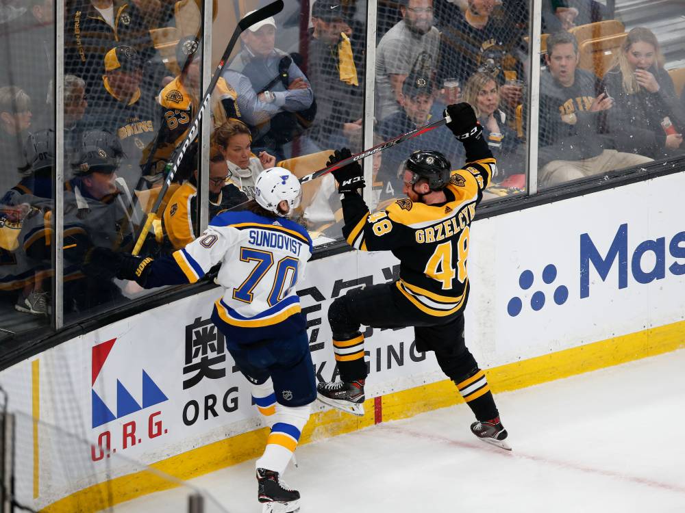 St. Louis Blues center Oskar Sundqvist (70) boards Boston Bruins defenseman Matt Grzelcyk (48) during the first period in game two of the 2019 Stanley Cup Final at TD Garden. — Reuters