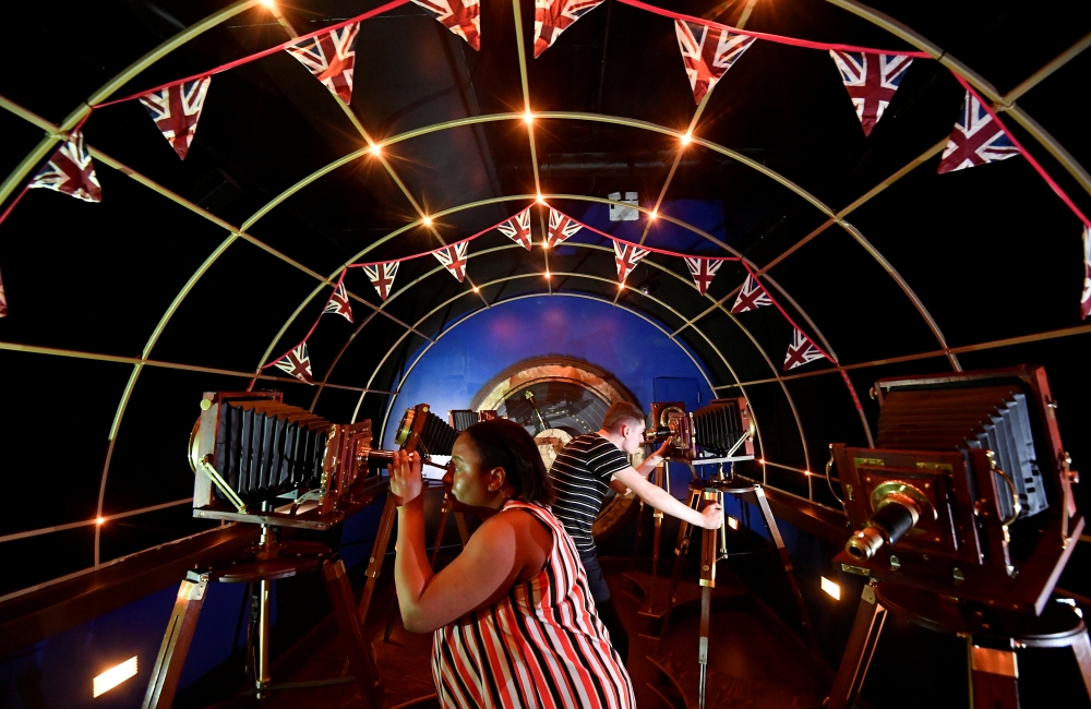 Visitors pose as they view 'Jeff Wayne's The War of The Worlds: The Immersive Experience' attraction, based on the book by HG Wells, in London. — Reuters