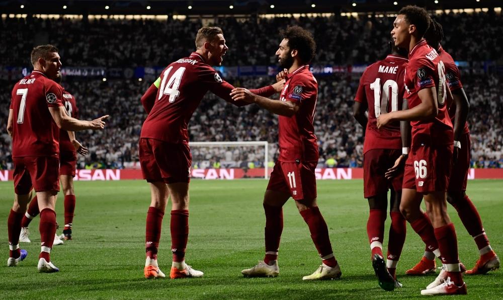 Liverpool's Belgian forward Divock Origi (L) celebrates with teammates after scoring his team's second goal during the UEFA Champions League final football match between Liverpool and Tottenham Hotspur at the Wanda Metropolitano Stadium in Madrid on Saturday. — AFP
