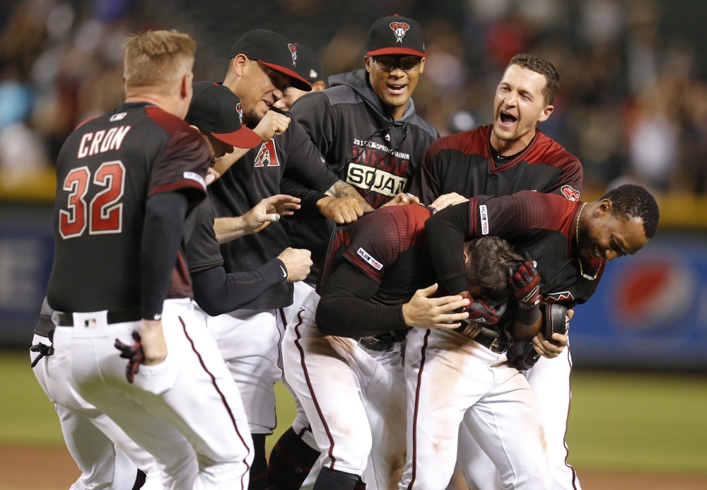 Arizona Diamondbacks center fielder Tim Locastro (16) celebrates with teammates after hitting a walk off hit to defeat the New York Mets in eleven innings during a baseball game at Chase Field in Phoenix, Arizona, on Saturday. — Reuters