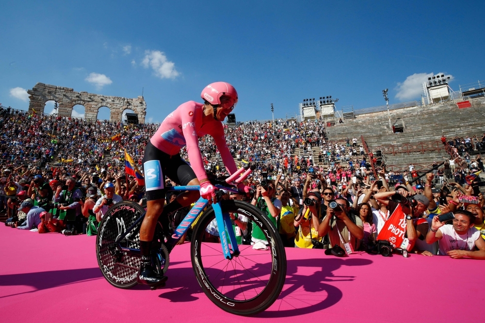 Overall race winner Team Movistar rider Ecuador's Richard Carapaz is thrown in the air by his teammates as they celebrate on the podium after stage twenty-one, the final stage of the 102nd Giro d'Italia - Tour of Italy - cycle race, a 17km individual time-trial in Verona on Sunday. — AFP