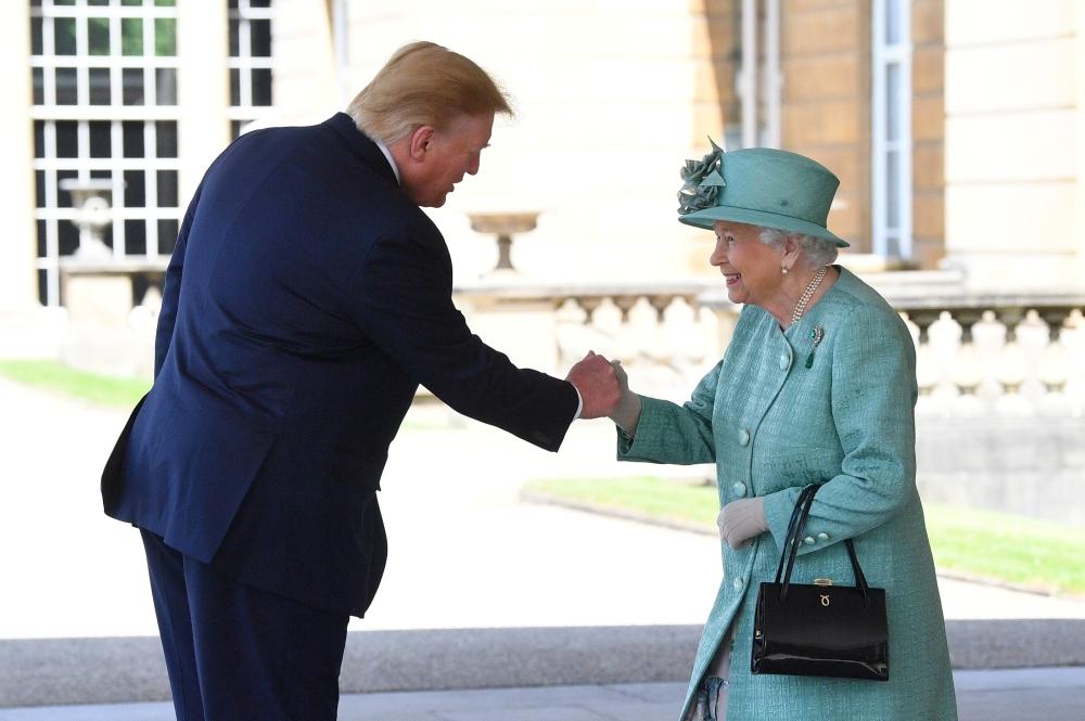 Britain's Queen Elizabeth II greets US President Donald Trump as he arrives for the Ceremonial Welcome at Buckingham Palace, in London, on Monday. — Reuters