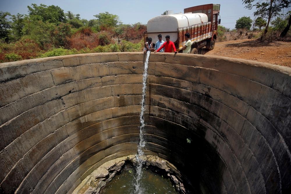 A dried-up well is refilled with water from a water tanker in Thane district in the western state of Maharashtra, India, in this May 30, 2019 file photo. — Reuters