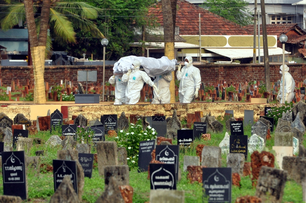 Doctors and relatives wearing protective gear carry the body of a victim, who lost his battle against the brain-damaging Nipah virus, during his funeral at a burial ground in Kozhikode, in the southern Indian state of Kerala, India, May 24, 2018. — Reuters