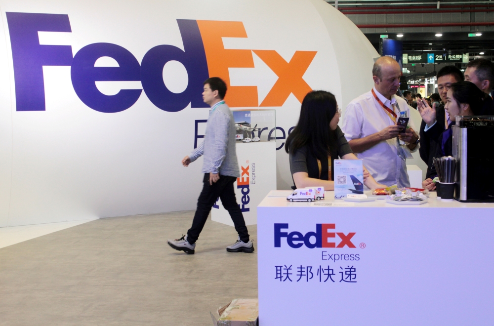 People visit a FedEx Express booth during the China International Import Expo (CIIE) at the National Exhibition and Convention Center in Shanghai, China November 7, 2018. — Reuters