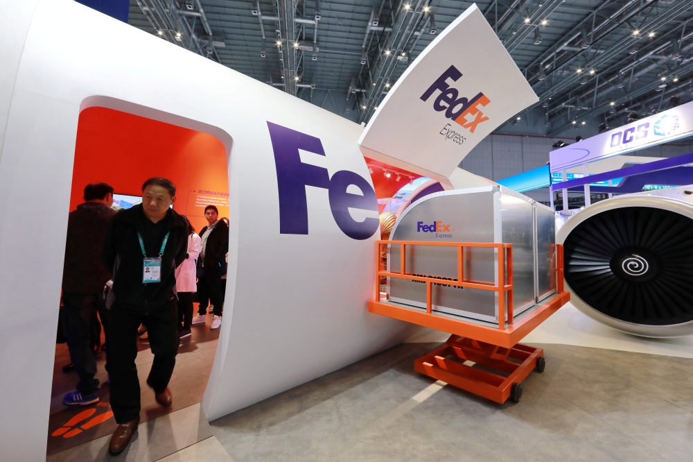 People visit a FedEx Express booth during the China International Import Expo (CIIE) at the National Exhibition and Convention Center in Shanghai, China November 7, 2018. — Reuters