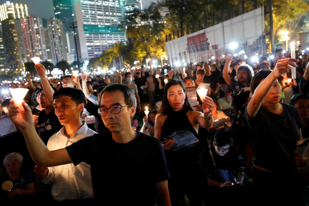 People take part in a candlelight vigil to mark the 30th anniversary of the crackdown of pro-democracy movement at Beijing's Tiananmen Square in 1989, at Victoria Park in Hong Kong, China, on Tuesday. — Reuters