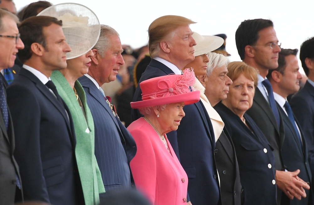 From left to right: Philip May, husband of Britain's Prime Minister Theresa May, French President Emmanuel Macron, Britain's Prime Minister Theresa May, Britain's Prince Charles, Prince of Wales, Britain's Queen Elizabeth II, US President Donald Trump, US First Lady Melania Trump, Greek President Prokopis Pavlopoulos, German Chancellor Angela Merkel, Dutch Prime Minister Mark Rutte and Luxembourg's Prime Minister Xavier Bettel attend an event to commemorate the 75th anniversary of the D-Day landings, in Portsmouth, southern England, on Wednesday. — AFP