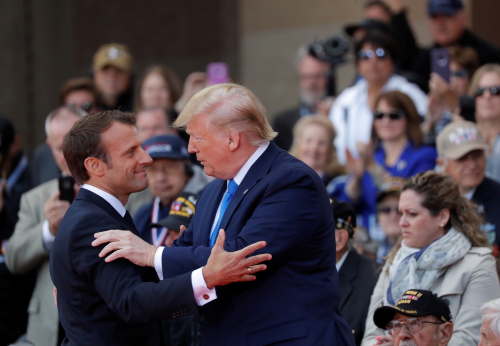 French President Emmanuel Macron helps a WWII veteran during the commemoration ceremony for the 75th anniversary of D-Day at the American cemetery of Colleville-sur-Mer in Normandy, France, Thursday. — Reuters