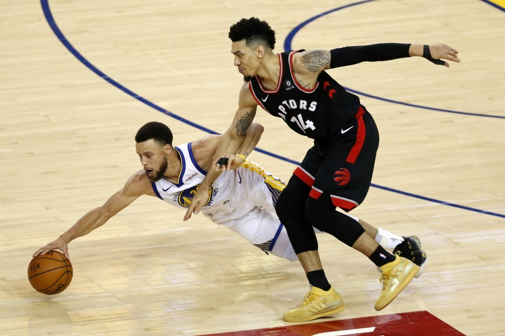 Stephen Curry No. 30 of the Golden State Warriors battles for the ball with Danny Green No. 14 of the Toronto Raptors in the second half during Game Three of the 2019 NBA Finals at ORACLE Arena on Wednesday n Oakland, California. — AFP