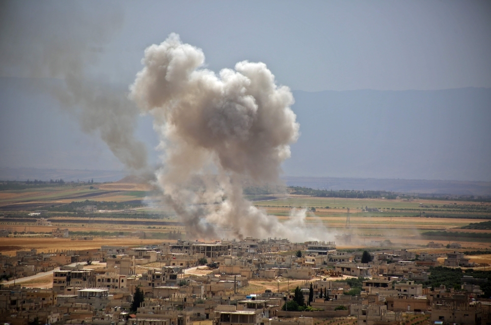 Plumes of smoke rise following reported Syrian government forces' bombardment on the town of Khan Sheikhun in the southern countryside of Idlib province on Thursday. — AFP