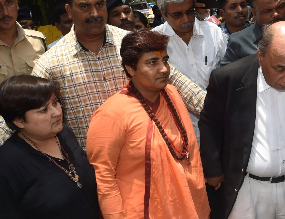 Indian MP for Prime Minister Narendra Modi's Bharatiya Janata Party (BJP) Sadhvi Pragya Thakur, center, arrives to appear in the special court in Mumbai on Friday. — AFP