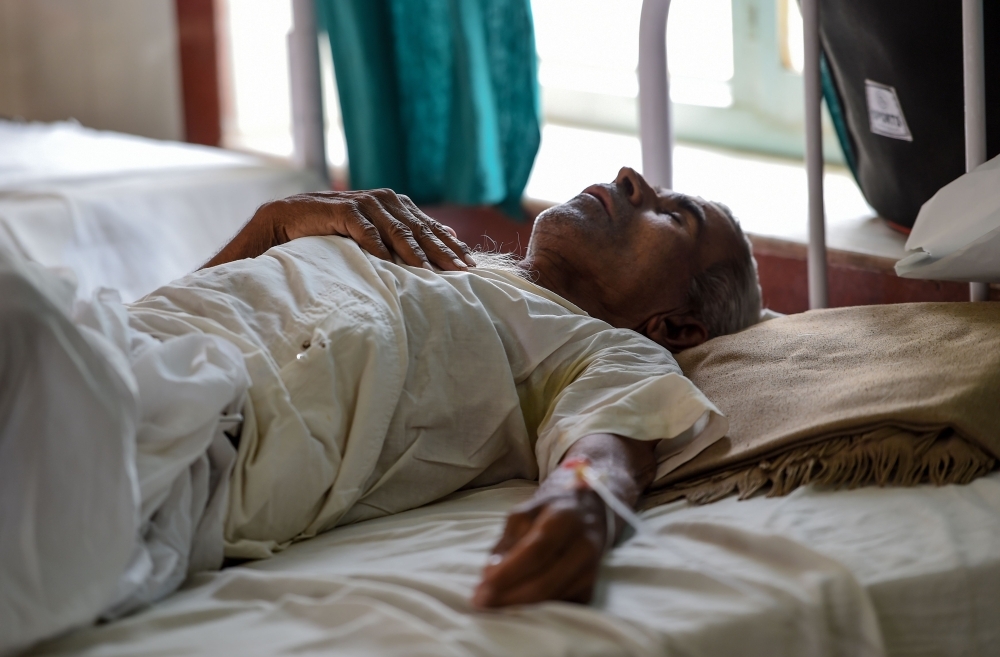 An Indian patient lies on a bed at a government hospital after suffering heat stroke, in Churu, Rajasthan, in this June 4, 2019 file photo. — AFP