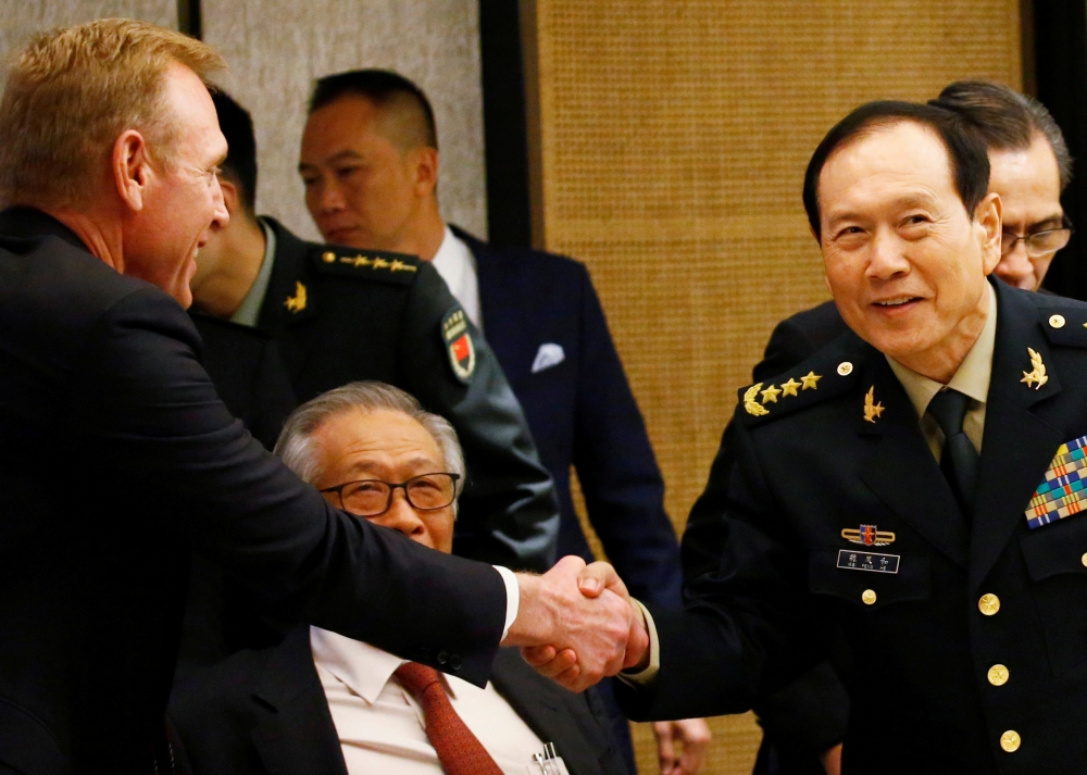 Acting US Defense Secretary Patrick Shanahan shakes hands with Chinese Defense Minister Wei Fenghe at a ministerial round-table at the IISS Shangri-la Dialogue in Singapore in this June 1, 2019 file photo. — Reuters