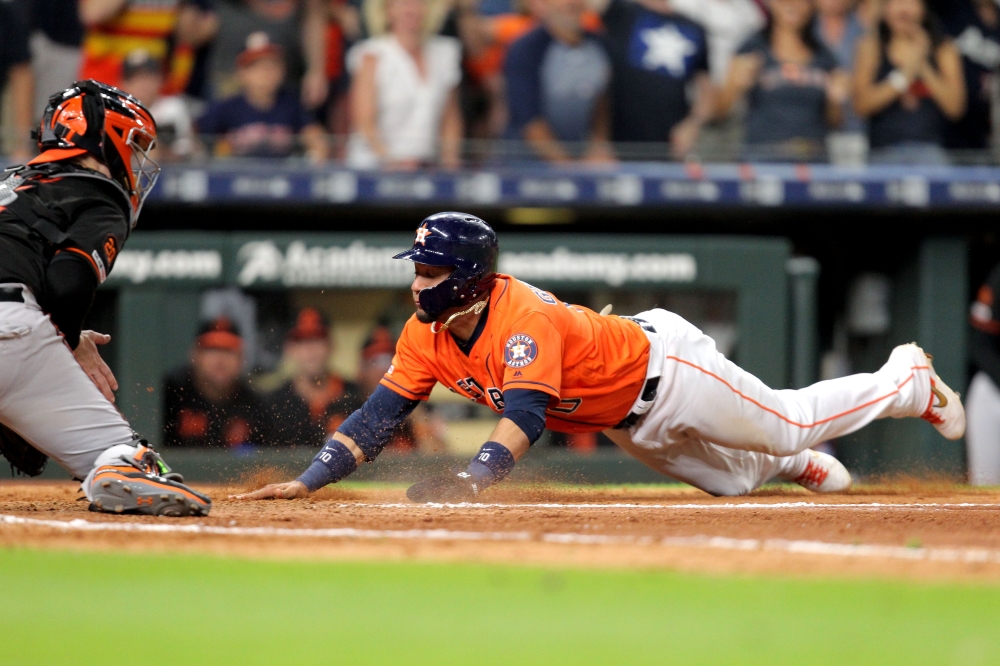 Houston Astros first baseman Yuli Gurriel (10) slides across home plate to score the winning run against the Baltimore Orioles during the eleventh inning at Minute Maid Park. — Reuters