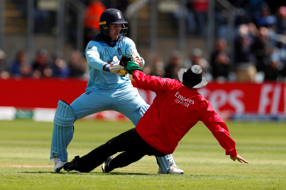 England's Jason Roy runs into and knocks the umpire over as he celebrates reaching a century against Bangladesh during the ICC Cricket World Cup match at the Cardiff Wales Stadium, Cardiff, Britain — Reuters