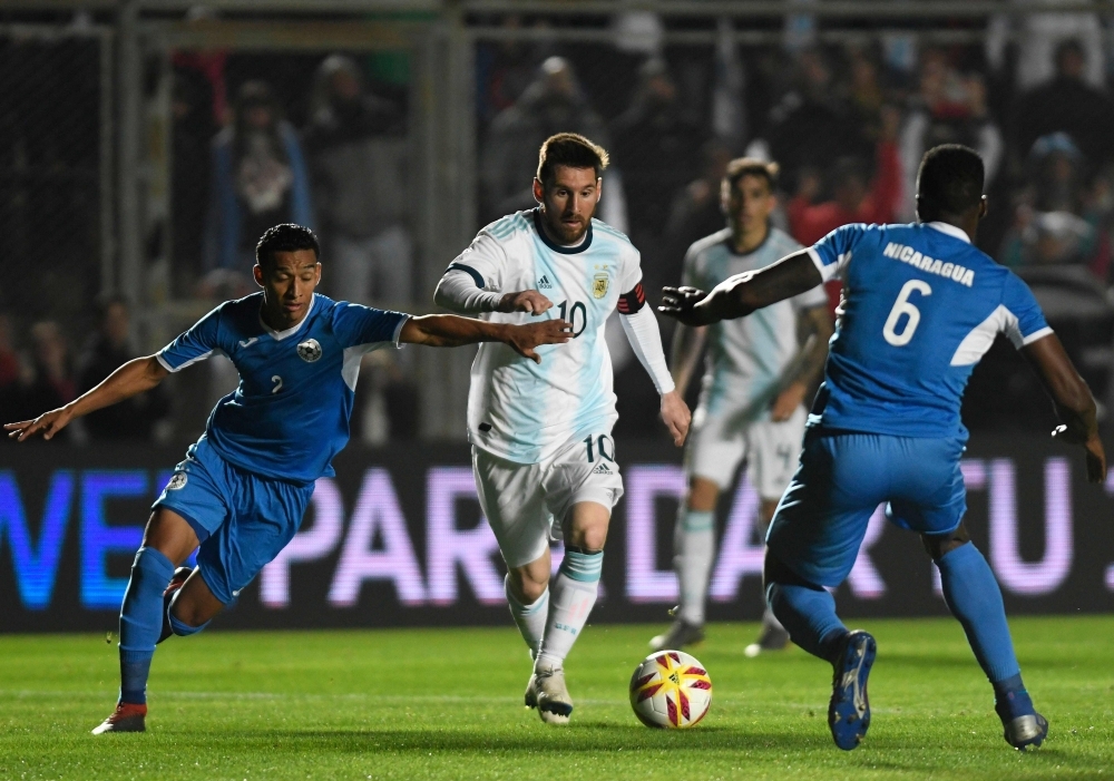 Argentina's Lionel Messi (C) is marked by Nicaragua's Josue Quijano (L) and Luis Fernando Copete during their international friendly football match at the San Juan del Bicentenario stadium in San Juan, Argentina, on Friday. — AFP