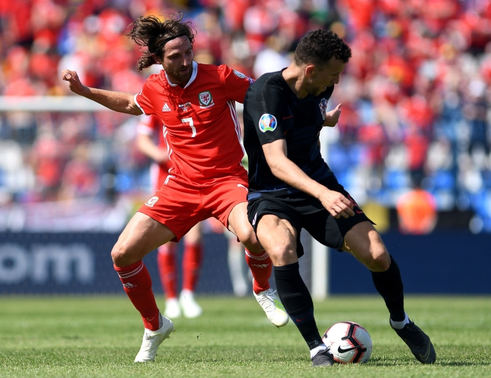 Croatia's forward Ivan Perisic (R) vies with Wales' midfielder Joe Allen during the Euro 2020 qualification football match between Croatia and Wales at Gradski vrt stadium in Osijek, Croatia, on Saturday. — AFP