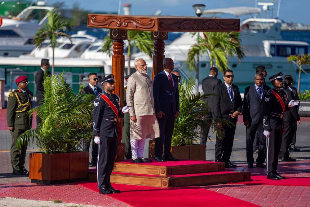 Indian Prime Minister Narendra Modi (center left) stands next to Maldives' President Ibrahim Mohamed Solih during a welcome ceremony at Republic Square in Maldive's capital Male, Saturday. Modi inaugurated a coastal radar system and military training center in the Maldives, as New Delhi seeks to fend off Chinese influence in the strategically-placed nation. — AFP