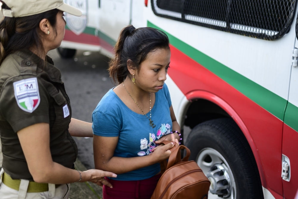 A Central American migrant traveling by public transportation system without papers is detained by Mexican migration agents in the outskirts of Tapachula, Chiapas state, Mexico, on Saturday. — AFP