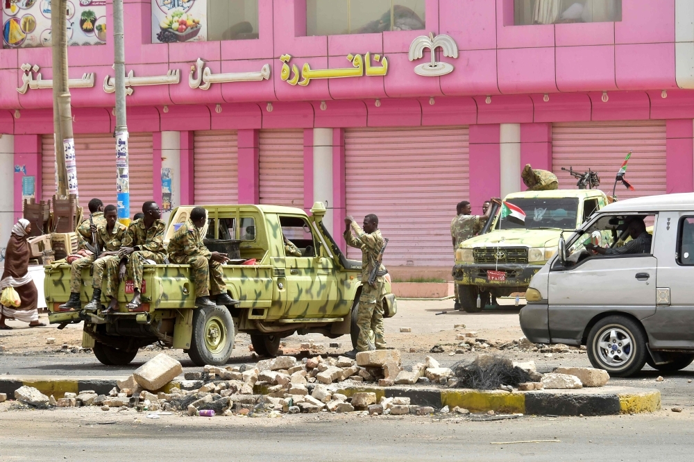 Sudanese soldiers stand guard at a street in Khartoum, Sunday. Police fired tear gas at protesters taking part in the first day of a civil disobedience campaign, called in the wake of a deadly crackdown on demonstrators. Protesters gathered tires, tree trunks and rocks to build new roadblocks in Khartoum's northern Bahari district, a witness told AFP, but riot police swiftly moved in and fired tear gas at them. — AFP
