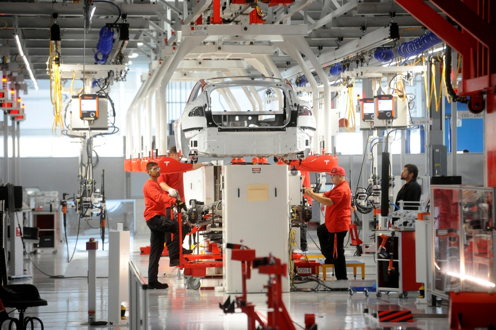 Flags fly over the Tesla Inc. Gigafactory 2, also known as RiverBend, a joint venture with Panasonic to produce solar panels and roof tiles in Buffalo, New York, US, Aug. 2, 2018, in this file photo.  — Reuters