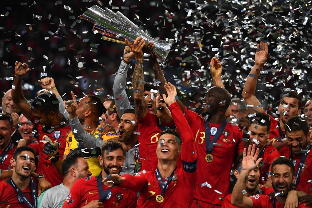 Portugal's forward Cristiano Ronaldo (front C) celebrates with teammates after the UEFA Nations League final football match between Portugal and The Netherlands at the Dragao Stadium in Porto on Sunday. — AFP