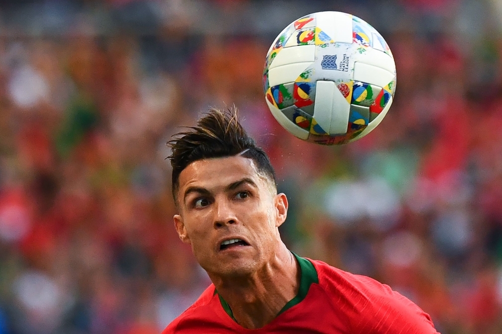 Portugal's forward Cristiano Ronaldo (front C) celebrates with teammates after the UEFA Nations League final football match between Portugal and The Netherlands at the Dragao Stadium in Porto on Sunday. — AFP