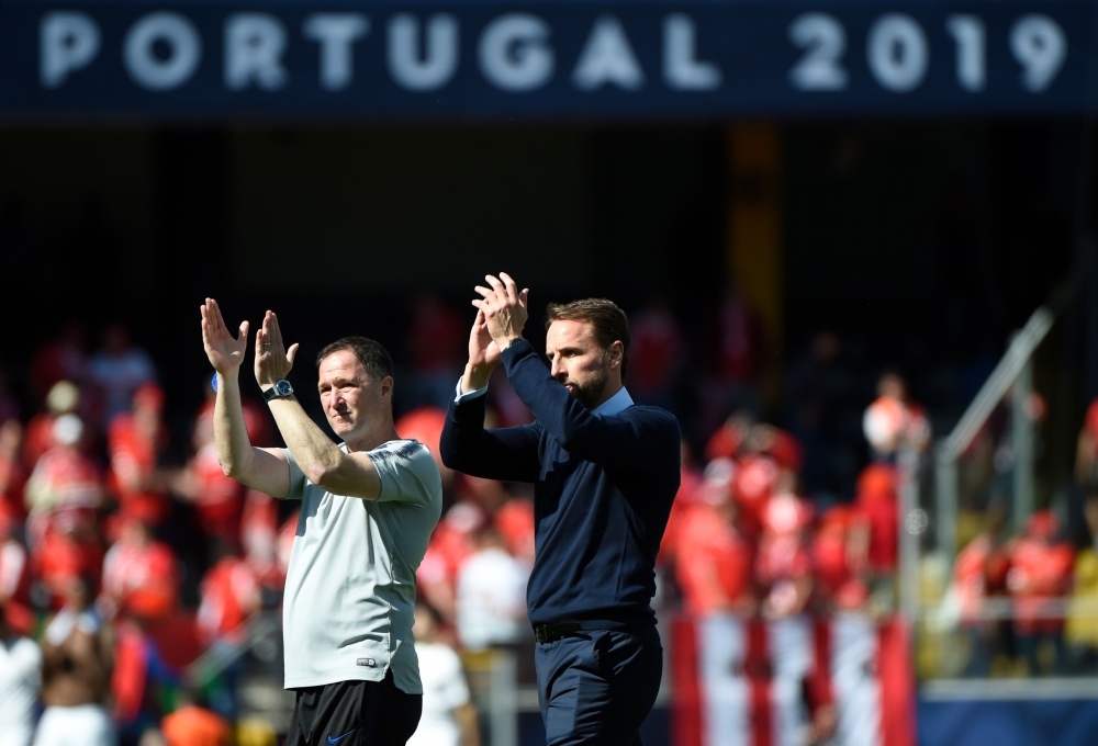 England's coach Gareth Southgate (R) celebrates their victory after the UEFA Nations League third place playoff football match against Switzerland at the Afonso Henriques Stadium in Guimaraes on Sunday. — AFP