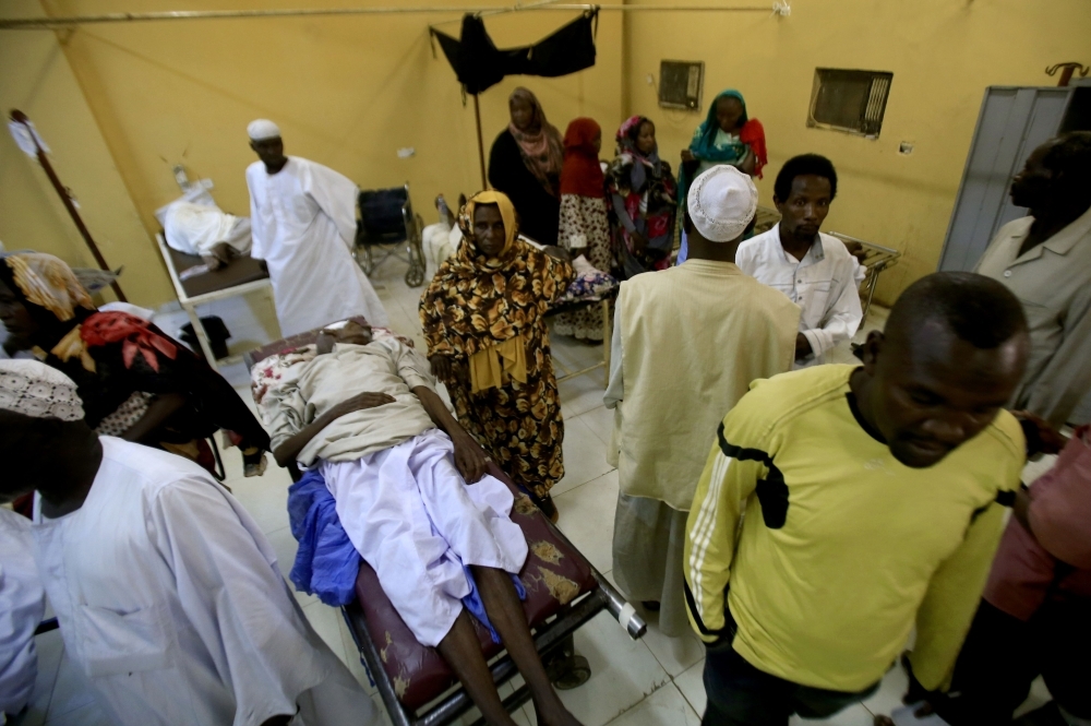 Patients in a hospital in Khartoum's twin city of Omdurman are shown receiving treatment during a visit organized by Sudan's Health Ministry which claimed medical services had been disrupted by protesters blocking roads as part as a civil disobedience campaign. — AFP