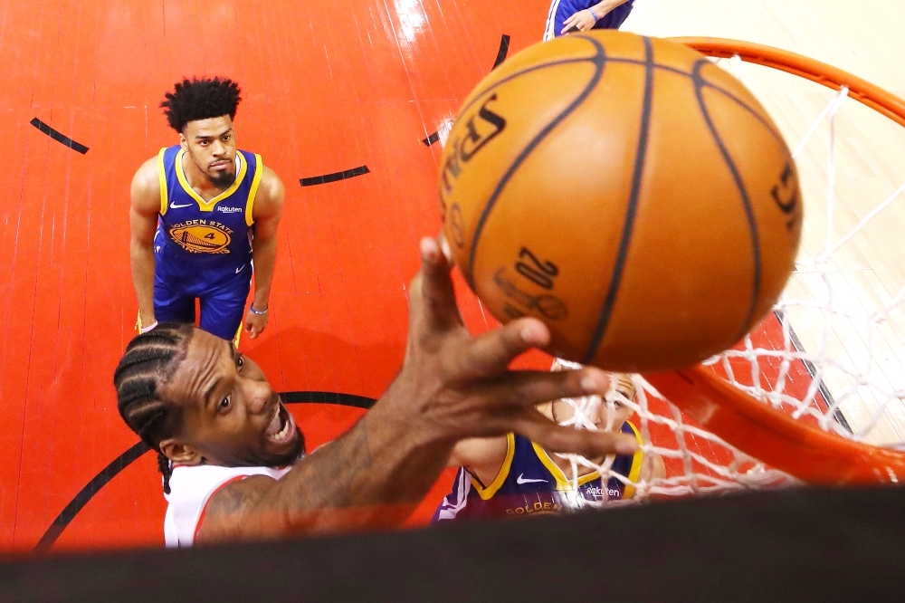 Golden State Warriors guard Stephen Curry (30) passes the ball over Toronto Raptors guard Kyle Lowry (7) during the fourth quarter in game five of the 2019 NBA Finals at Scotiabank Arena. — Reuters