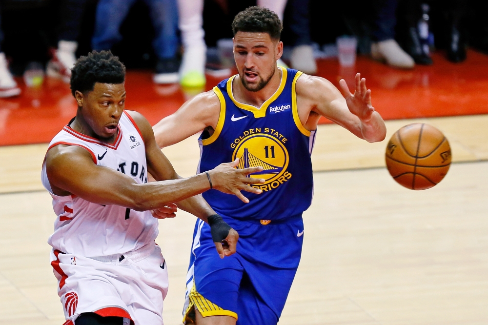 Golden State Warriors guard Stephen Curry (30) passes the ball over Toronto Raptors guard Kyle Lowry (7) during the fourth quarter in game five of the 2019 NBA Finals at Scotiabank Arena. — Reuters