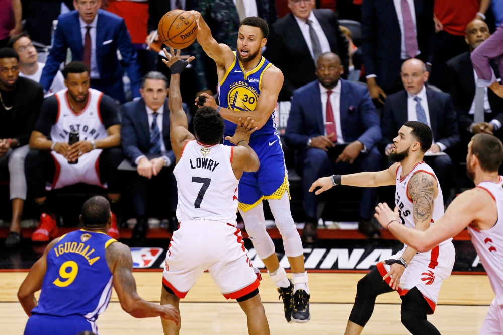 Golden State Warriors guard Stephen Curry (30) passes the ball over Toronto Raptors guard Kyle Lowry (7) during the fourth quarter in game five of the 2019 NBA Finals at Scotiabank Arena. — Reuters